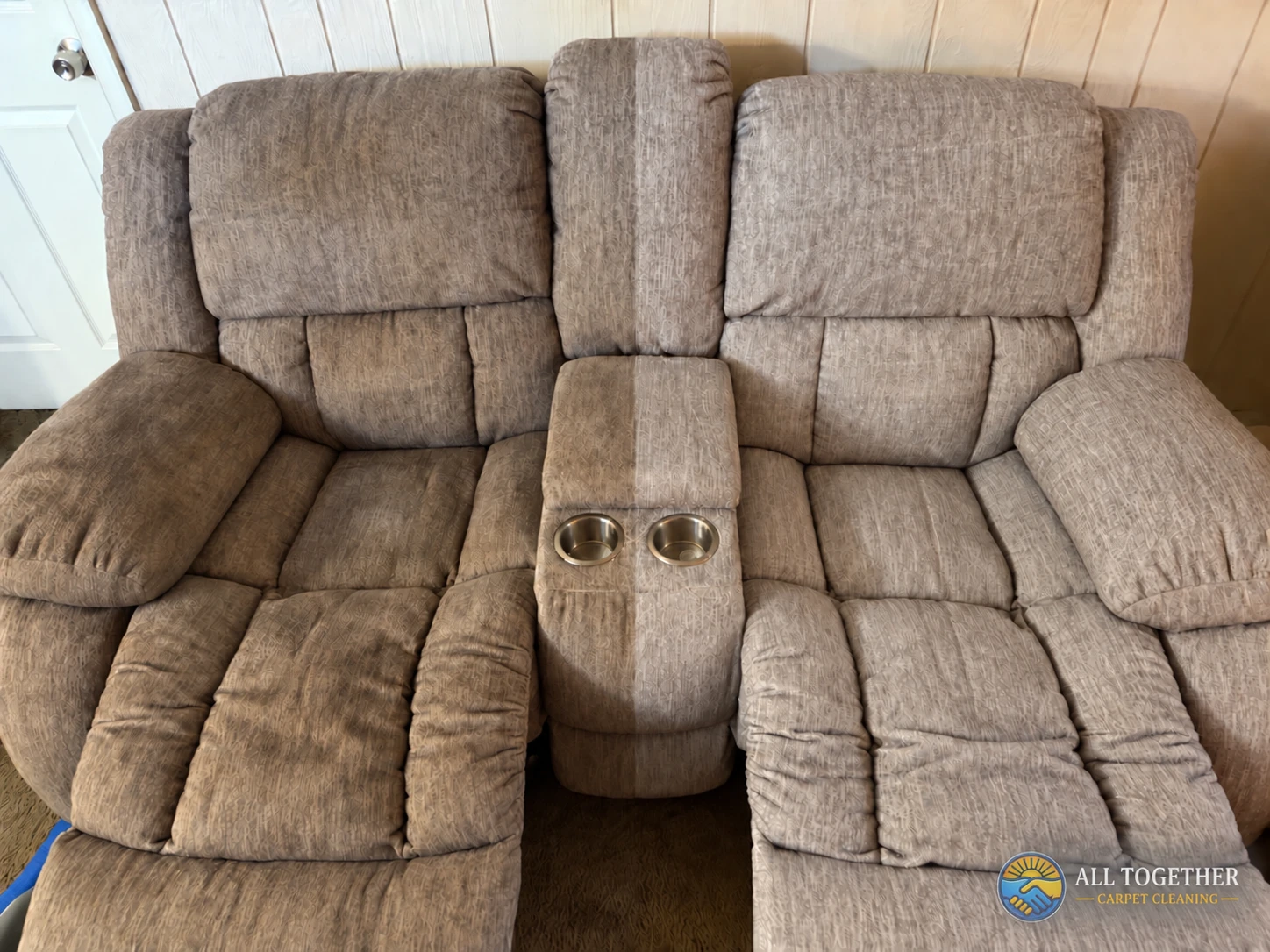 Patterned reclining loveseat with a center console