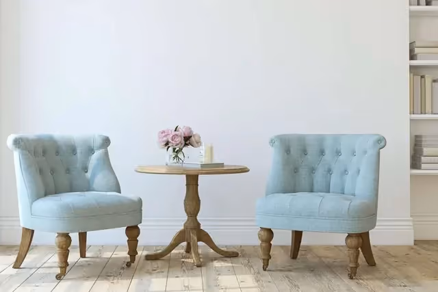 Two upholstered chairs beside a small table